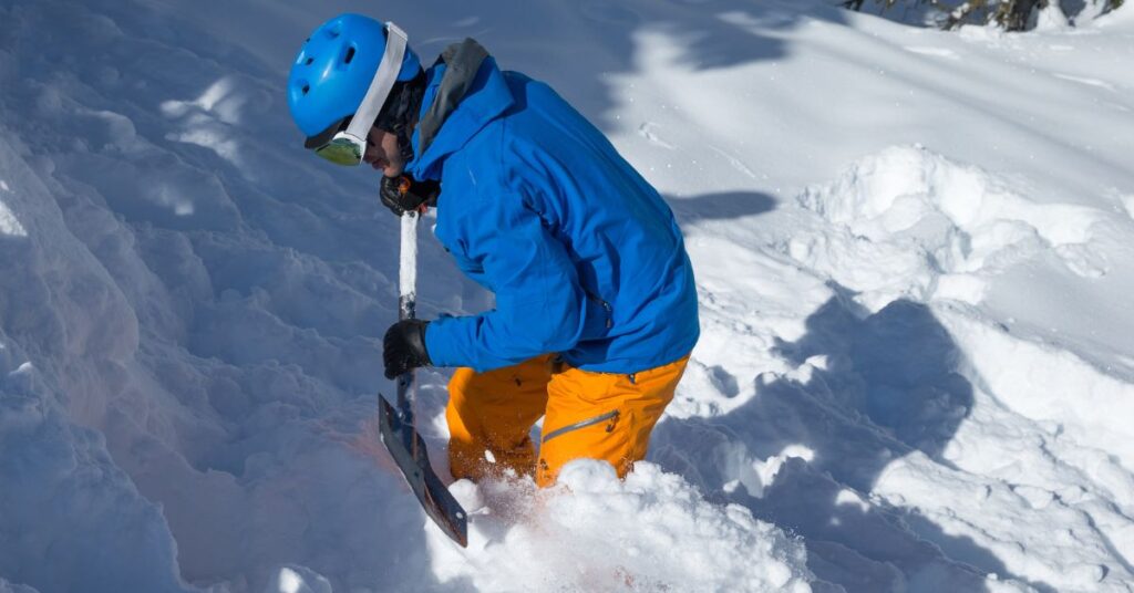 A student in an avalanche education course digging after a probe strike