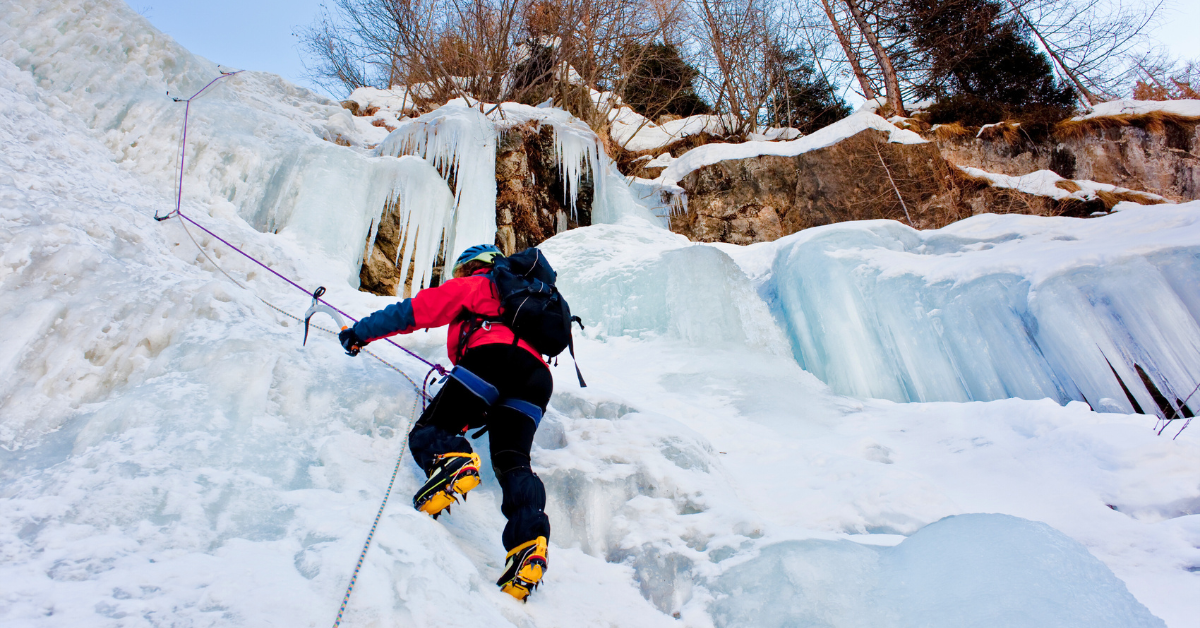 Ice-climber-following-up-an-ice-route-during-course-for-beginners