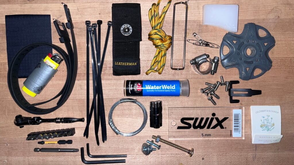 A photo of the items that should be in a backcountry ski repair kit