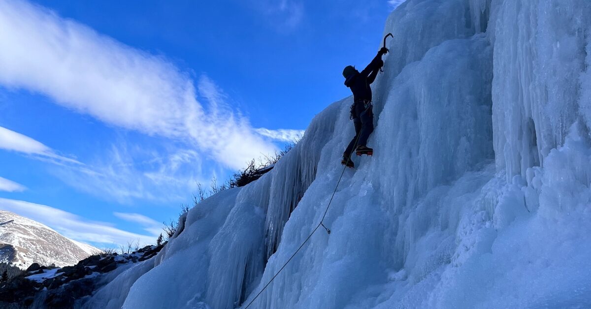 An ice climber high up on Lincoln Falls