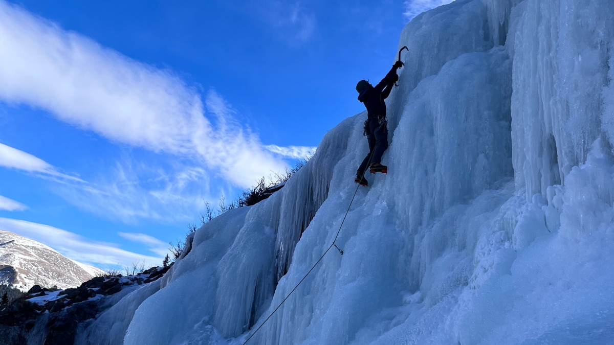 An ice climber high up on Lincoln Falls