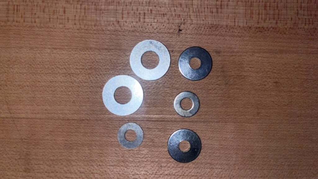 An assortment of washers in a backcountry ski repair kit